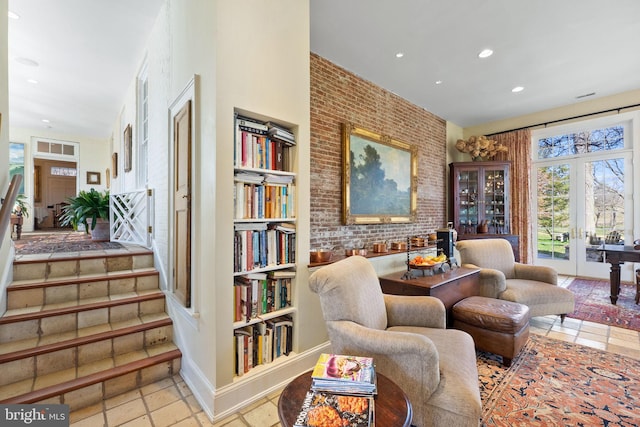 living area with french doors and brick wall