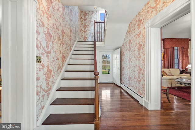 staircase featuring hardwood / wood-style floors and a baseboard heating unit