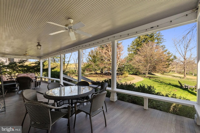 sunroom / solarium featuring ceiling fan