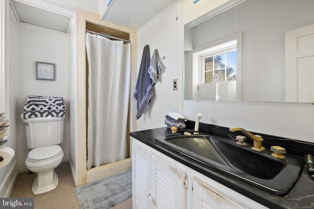 bathroom featuring vanity, toilet, walk in shower, and crown molding