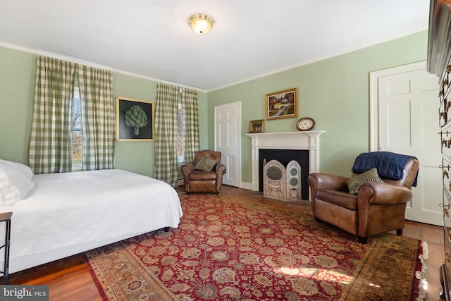 bedroom with crown molding and dark wood-type flooring