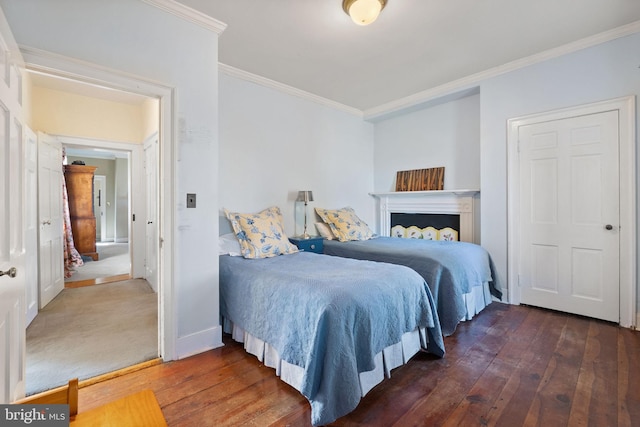 bedroom featuring crown molding and dark wood-type flooring