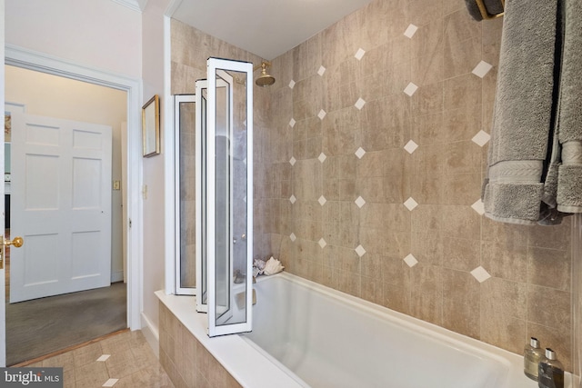 bathroom featuring tile patterned floors and tiled shower / bath