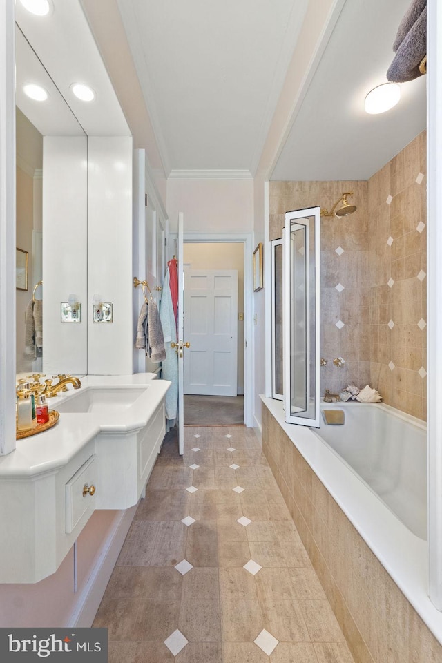 bathroom with tile patterned floors, vanity, shower / bath combination with glass door, and crown molding