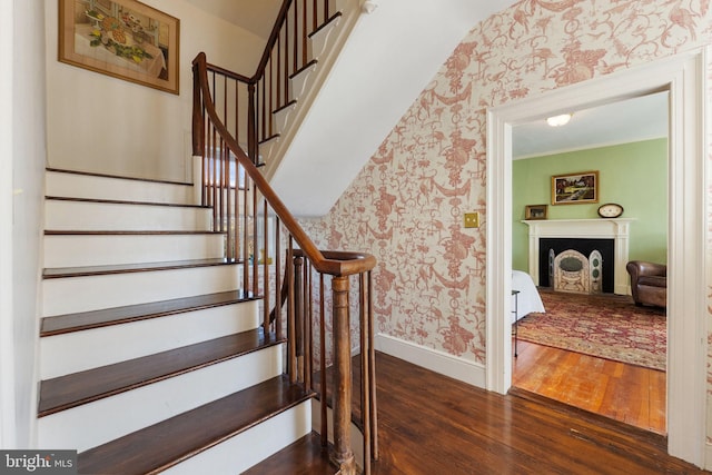 staircase featuring hardwood / wood-style flooring and ornamental molding