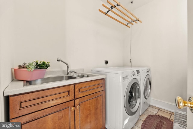 clothes washing area with cabinets, light tile patterned floors, separate washer and dryer, and sink