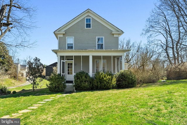 rear view of house with a yard and a sunroom