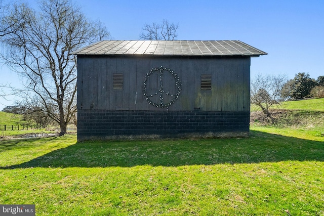 view of outbuilding featuring a lawn