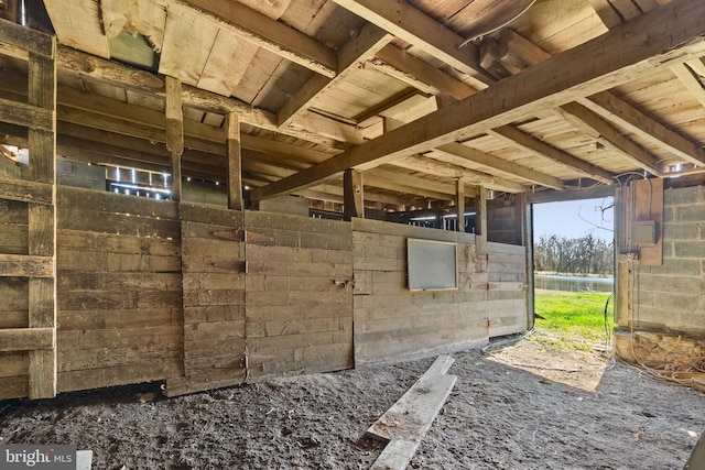 view of horse barn featuring a water view