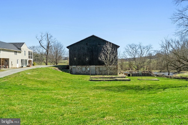 view of outbuilding featuring a lawn