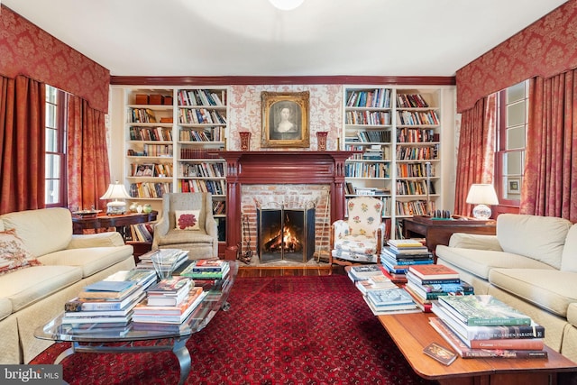 living room featuring built in features and a brick fireplace