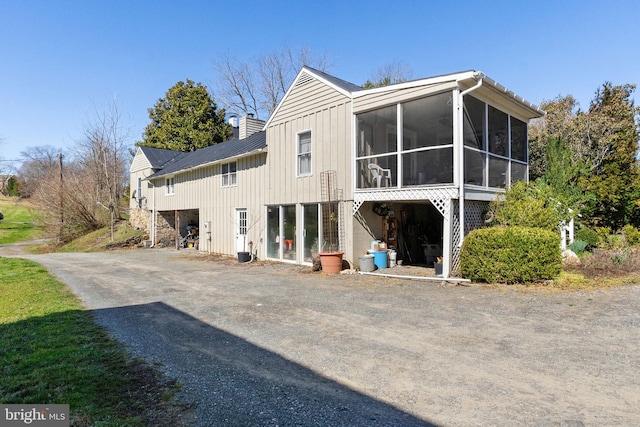 back of property featuring a sunroom