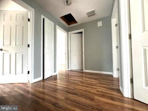 interior space with visible vents, baseboards, and wood finished floors