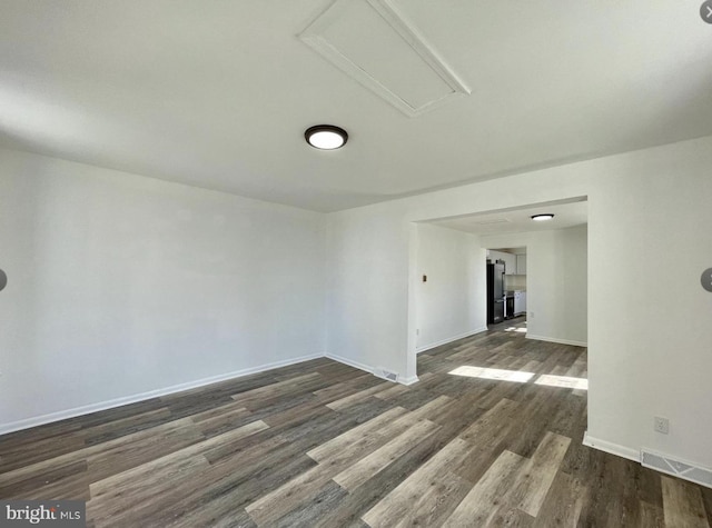 unfurnished room with dark hardwood / wood-style floors