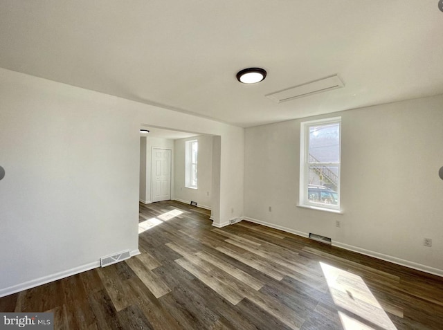 spare room with dark wood-type flooring