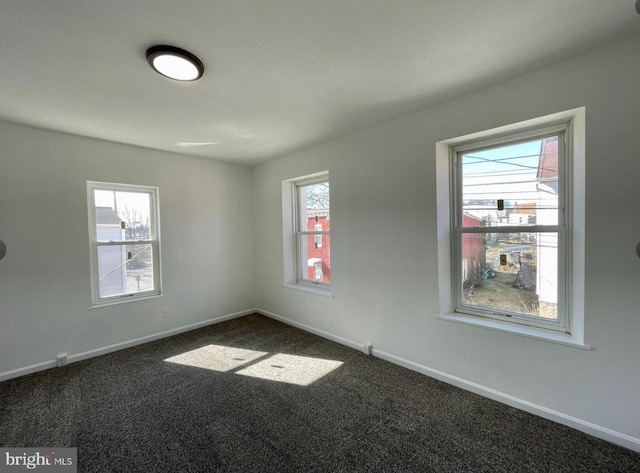 empty room featuring dark carpet