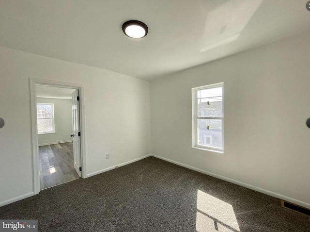 carpeted spare room with plenty of natural light