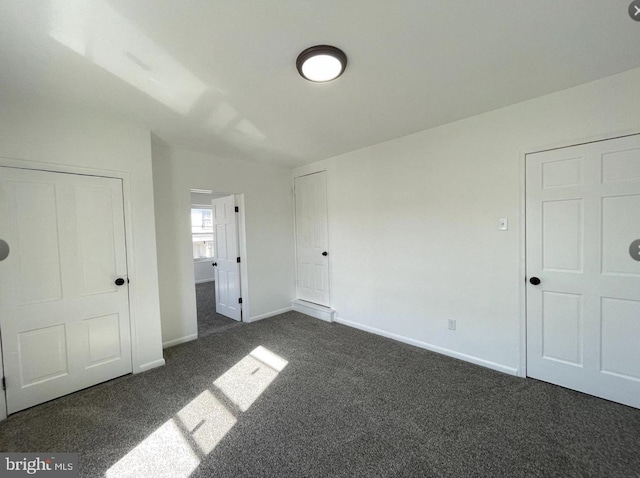 unfurnished bedroom featuring dark colored carpet