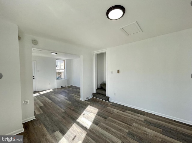 spare room with dark hardwood / wood-style floors