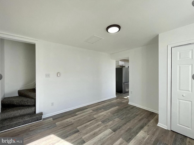 spare room featuring dark wood-type flooring