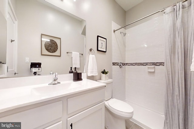 bathroom with tile flooring, toilet, and large vanity