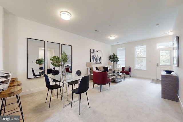 dining space with light colored carpet