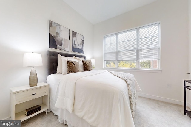 bedroom featuring light carpet