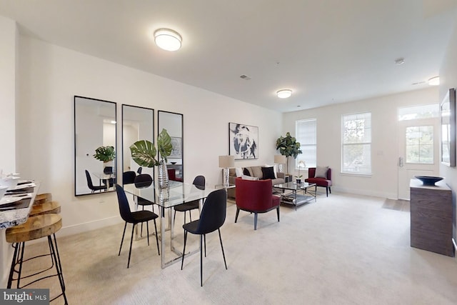 dining room featuring light colored carpet