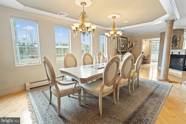 dining space with light hardwood / wood-style floors, a chandelier, and a wealth of natural light