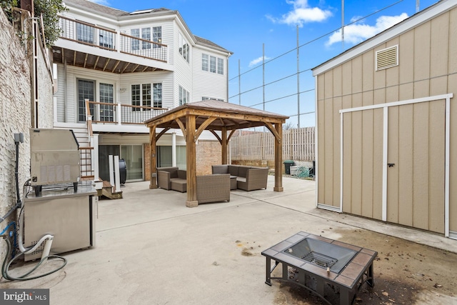 view of patio with a balcony, a gazebo, and an outdoor living space