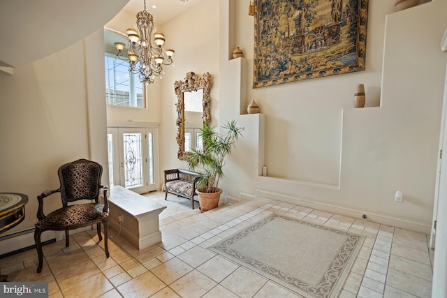 living area with an inviting chandelier, light tile floors, and a high ceiling