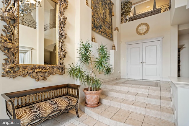 interior space featuring a notable chandelier and a towering ceiling