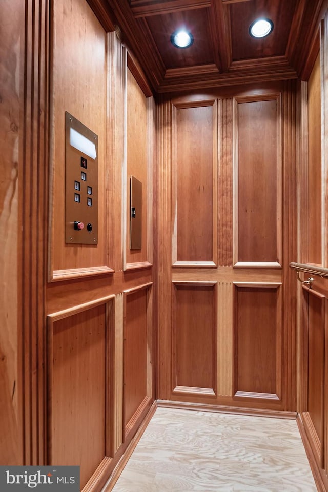 interior details with crown molding, wooden walls, coffered ceiling, and wood-type flooring