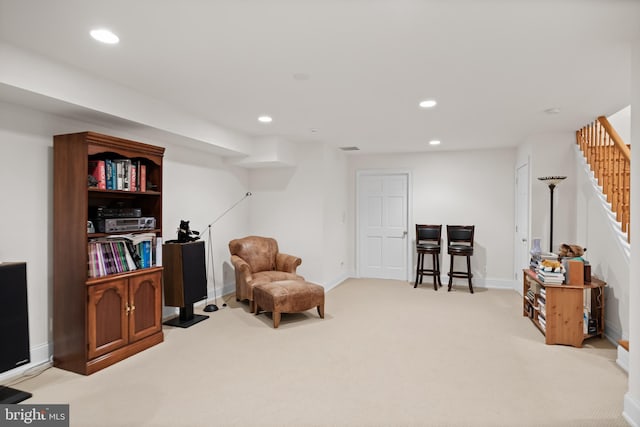 living area with light carpet