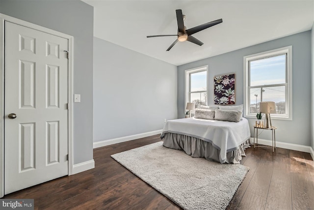 bedroom with ceiling fan and dark hardwood / wood-style flooring