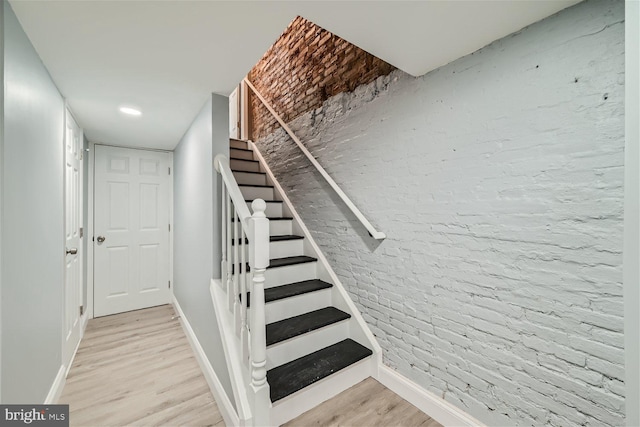 staircase with light hardwood / wood-style flooring