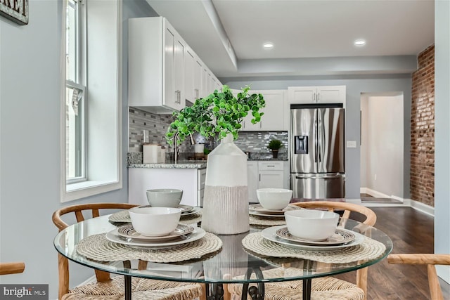 dining space featuring dark wood-type flooring