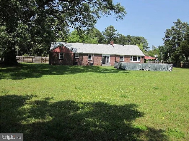 back of property featuring a lawn