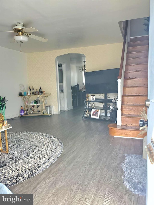 living room with dark hardwood / wood-style flooring and ceiling fan