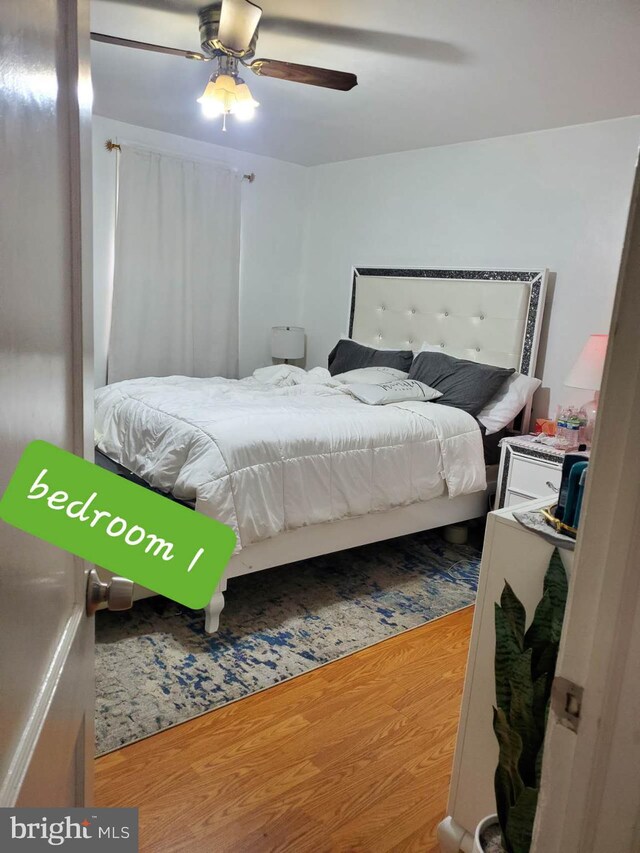 bedroom featuring hardwood / wood-style floors and ceiling fan