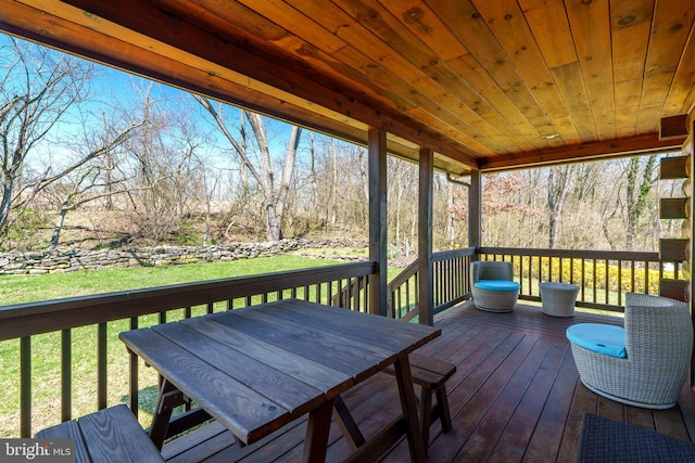 wooden deck with a lawn