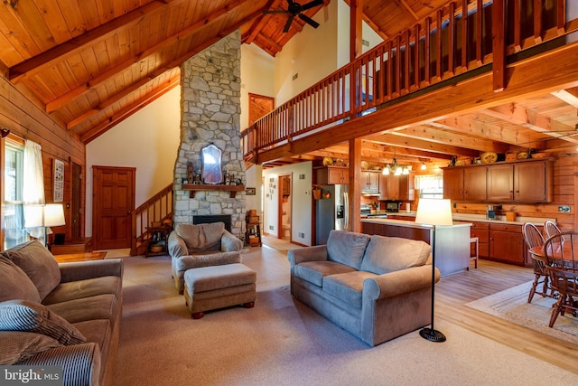 living room with light wood-type flooring, high vaulted ceiling, a healthy amount of sunlight, and wood ceiling