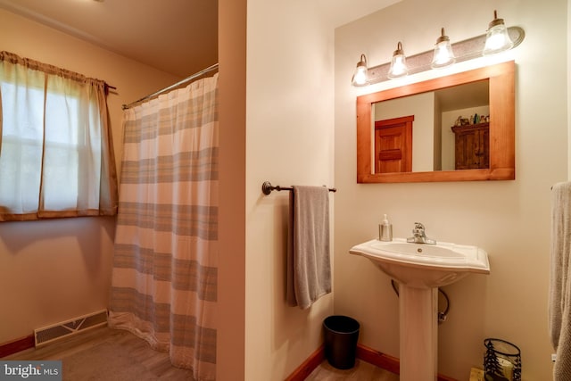 bathroom with hardwood / wood-style floors and a shower with curtain