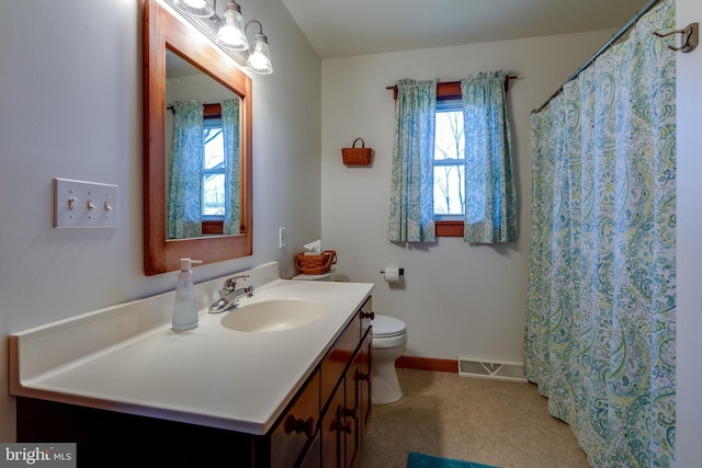 bathroom featuring vanity and toilet