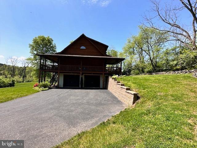 view of property exterior with a lawn, a deck, and a garage