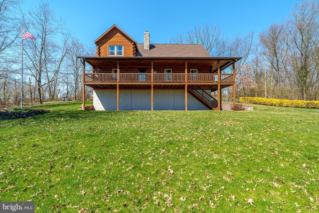 rear view of property with a lawn and a deck