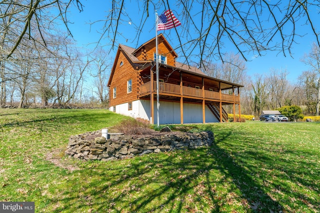 rear view of house featuring a lawn and a wooden deck