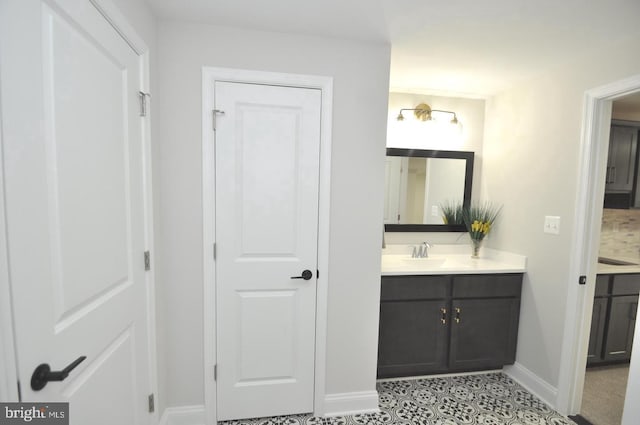 bathroom featuring vanity, backsplash, and tile patterned floors