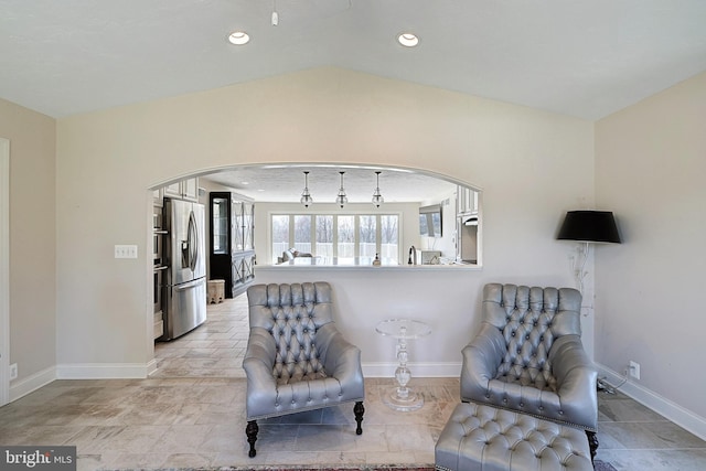 living area with vaulted ceiling and light tile floors