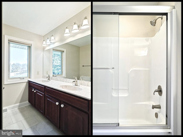 bathroom with tile flooring, oversized vanity, dual sinks, and enclosed tub / shower combo